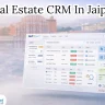 Laptop displaying a Real Estate CRM dashboard with leads, sales pipeline, and property inventory, set against a blurred Delhi skyline – representing Real Estate CRM in Jaipur.